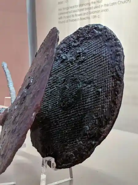 Close-up of iron tongs seal with lily and knob